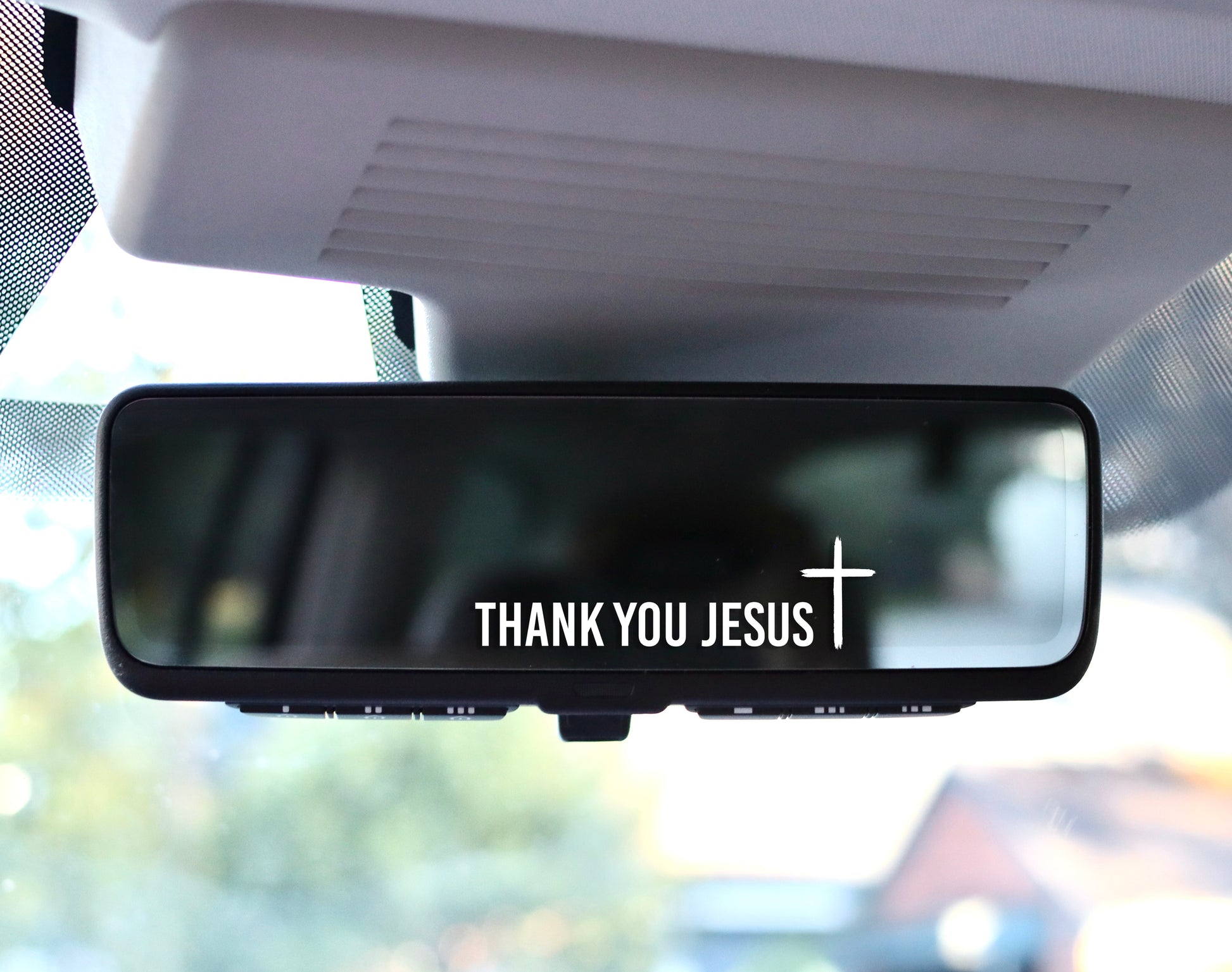 Rearview mirror with ‘THANK YOU JESUS’ decal and small cross in white