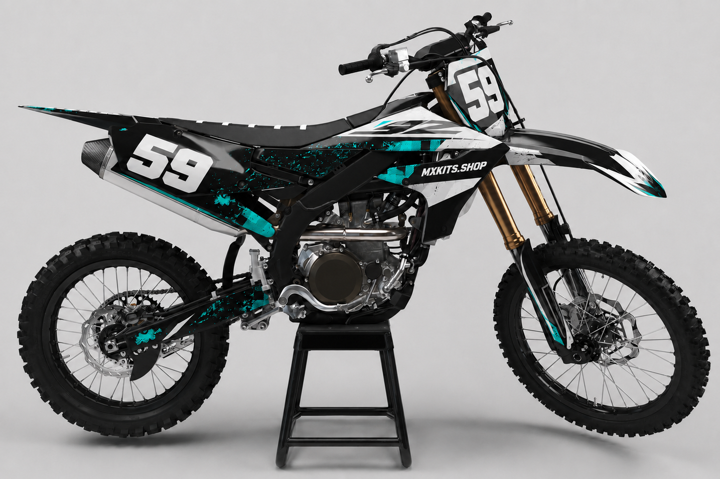 Black and white Yamaha motocross bike with turquoise splatter graphics and race number 59