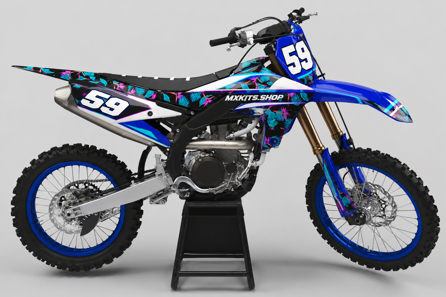 Blue Yamaha motocross bike wearing a tropical cyan and magenta graphics set with race number 59
