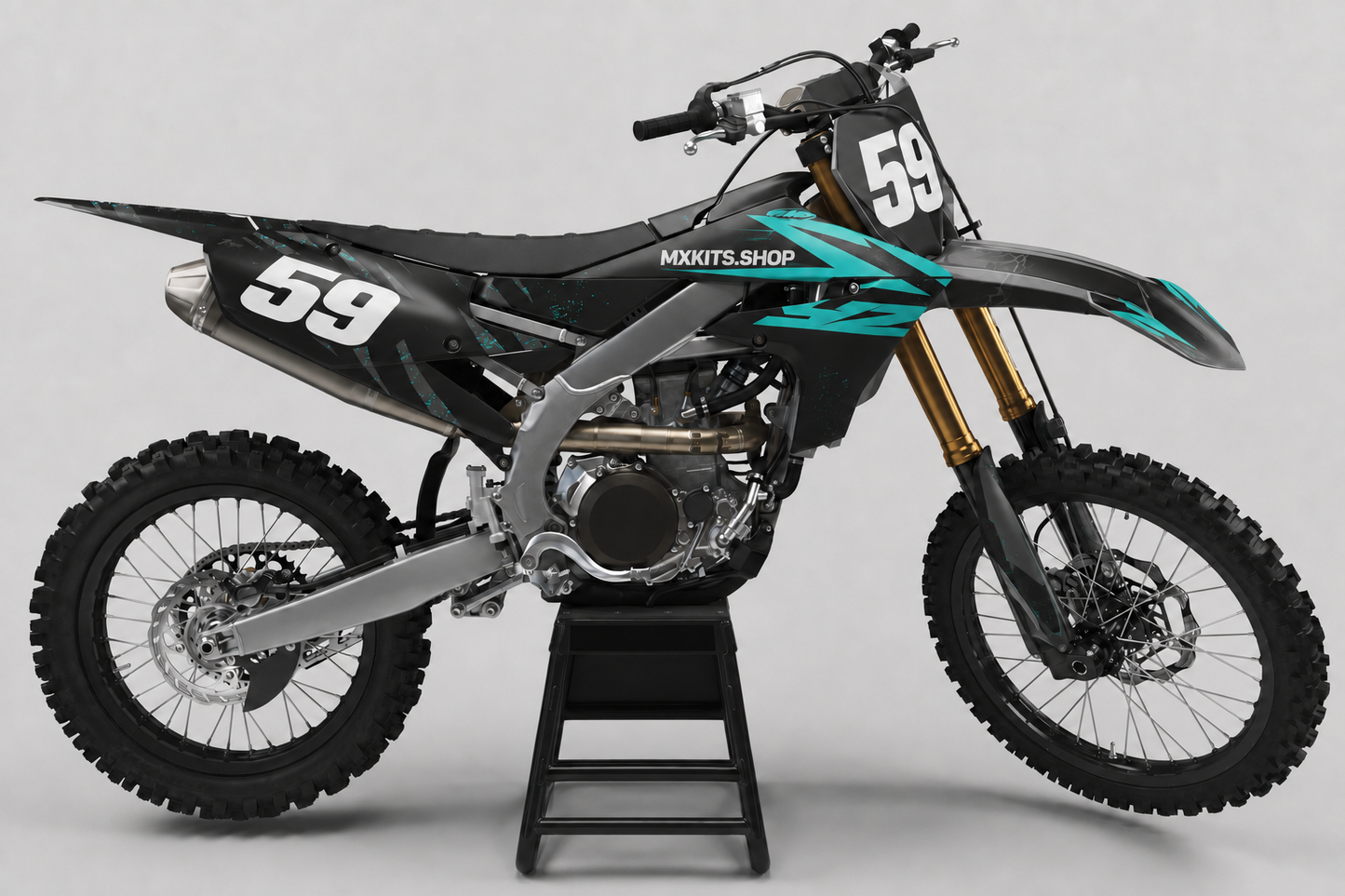 Charcoal Yamaha motocross bike with turquoise angular graphics, subtle splatter and race number 59